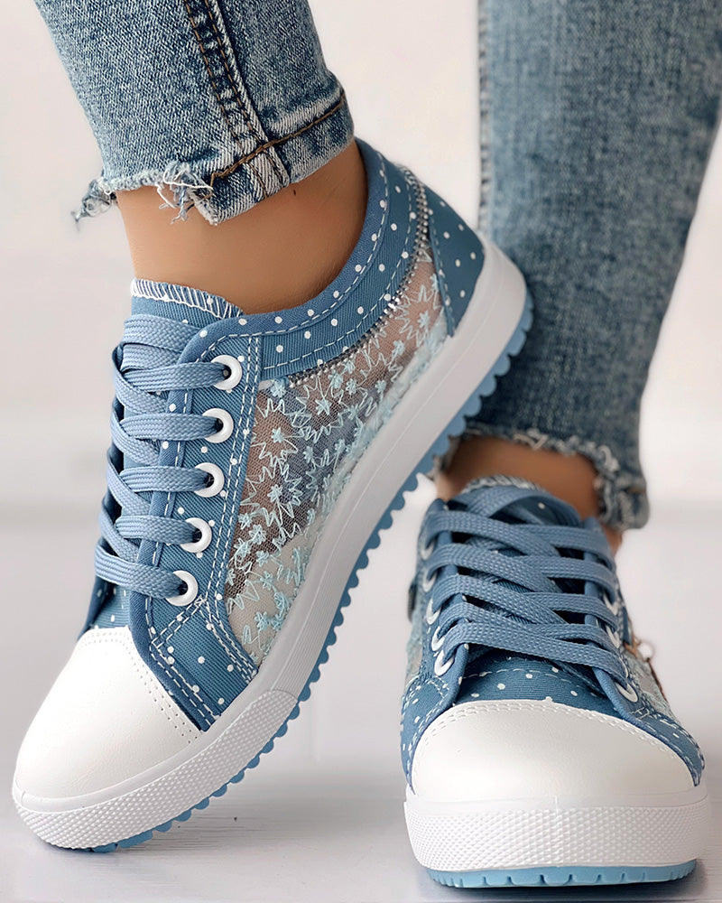 White-soled sneakers with floral embroidery, polka dots, lace panels, and light blue ripped jeans.