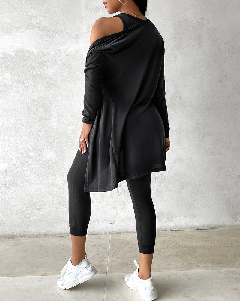 Black tank top, long sleeve coat with one shoulder exposed, and matching black pants.