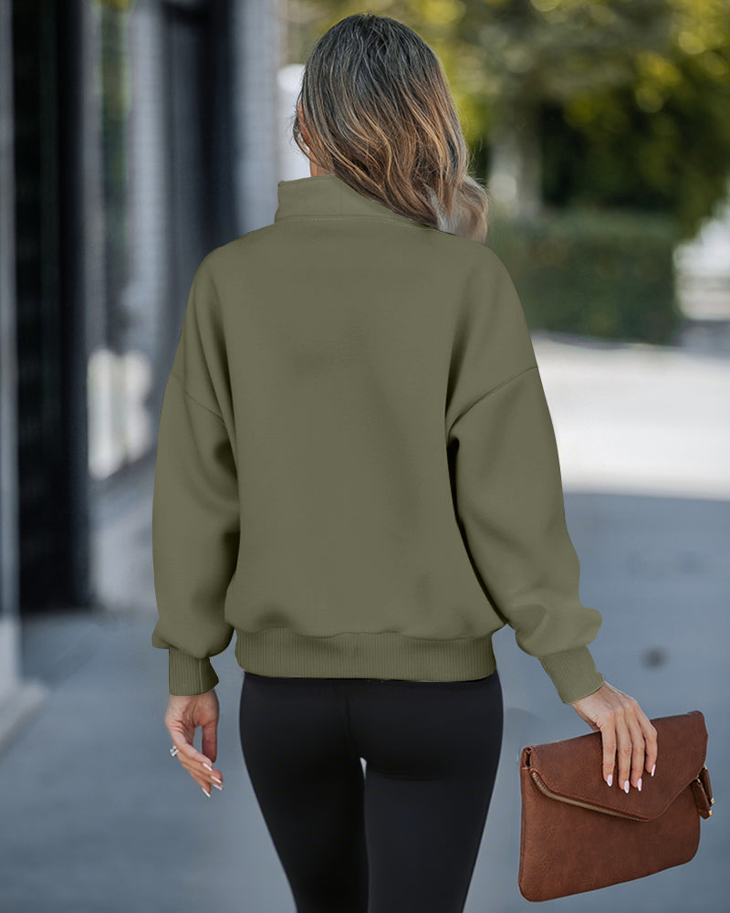 Olive green high neck half-zip sweatshirt with kangaroo pocket and drop shoulders, black leggings.