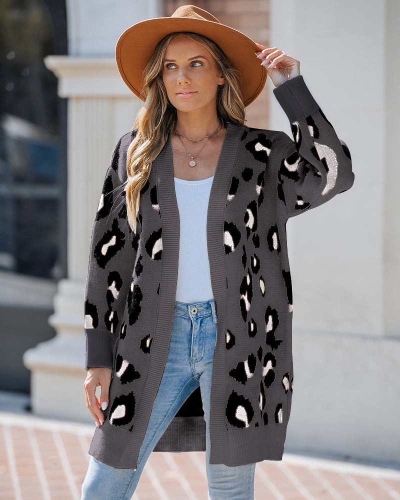 Leopard print longline open-front cardigan layered over a white top and light blue jeans.