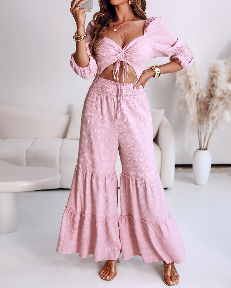 Light pink shirred ruffle hem wide leg jumpsuit with sweetheart neck and puff sleeves.