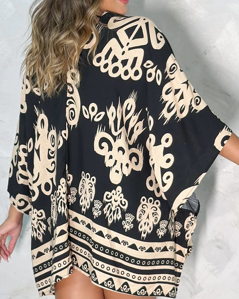 A vintage baroque print open front cardigan featuring a hollow-out back design.
