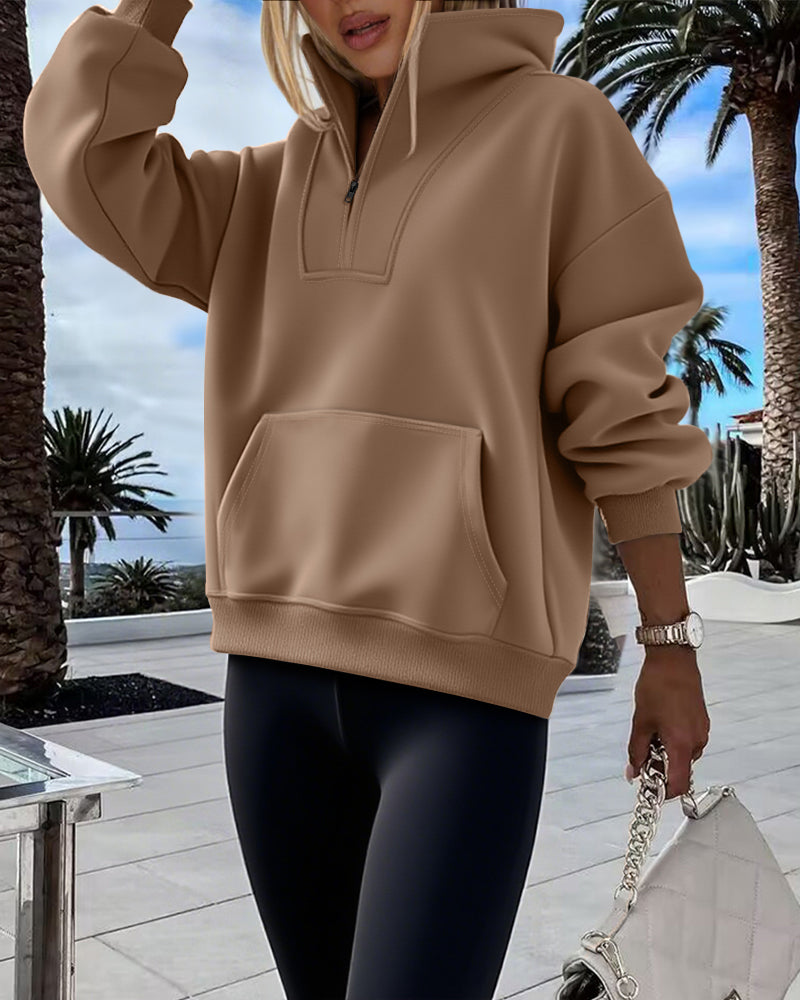 Tan High Neck Half-Zip Sweatshirt with Kangaroo Pocket and Drop Shoulders, paired with black leggings.