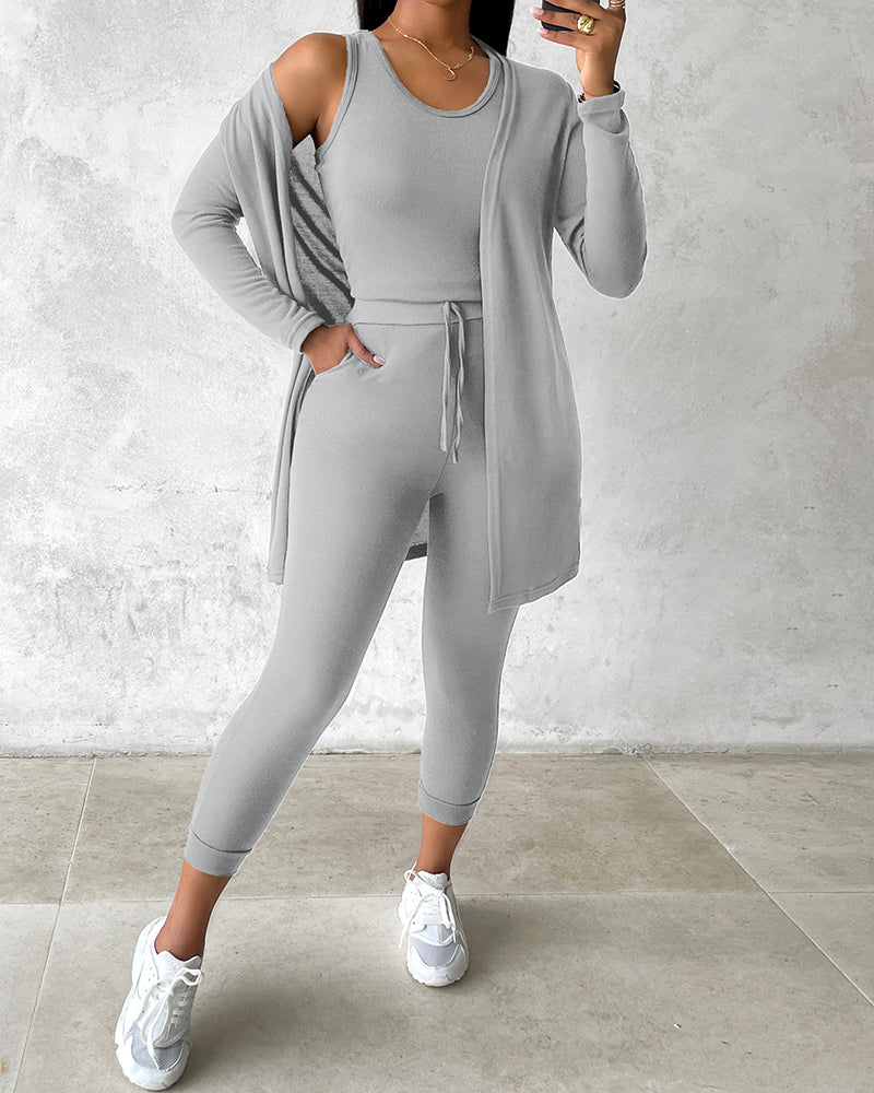 Light gray KOAD'CLO tank top, long sleeve coat, and pants set.