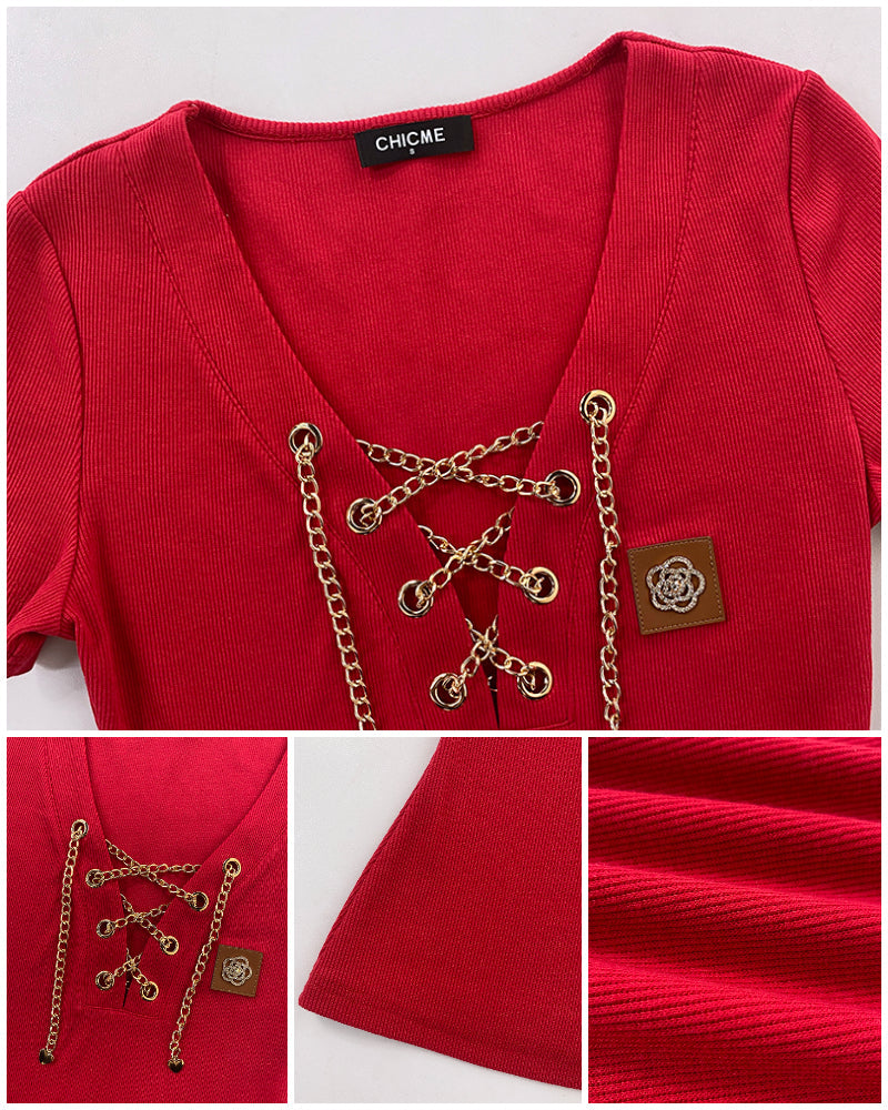 Red V-neck T-shirt with lace-up rhinestone detail, decorative patch, short sleeves, ribbed texture.