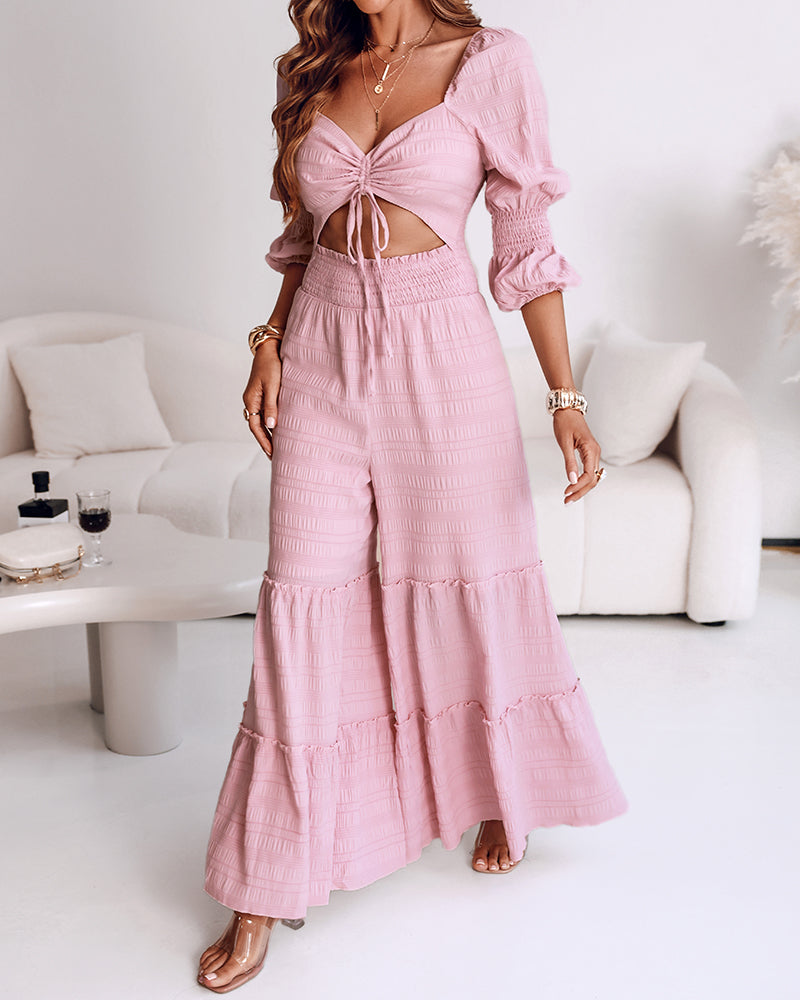 KOAD'CLO jumpsuit with sweetheart neck, puff sleeves, shirred waist, and ruffle wide legs.