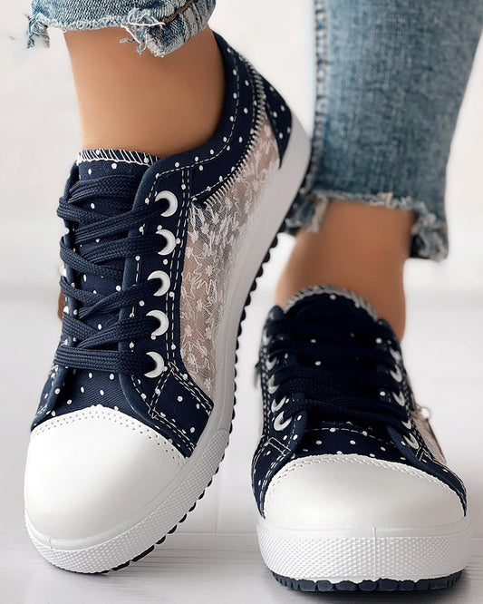 KOAD'CLO floral embroidered polka dot sneakers with white lace panels and light blue frayed jeans.