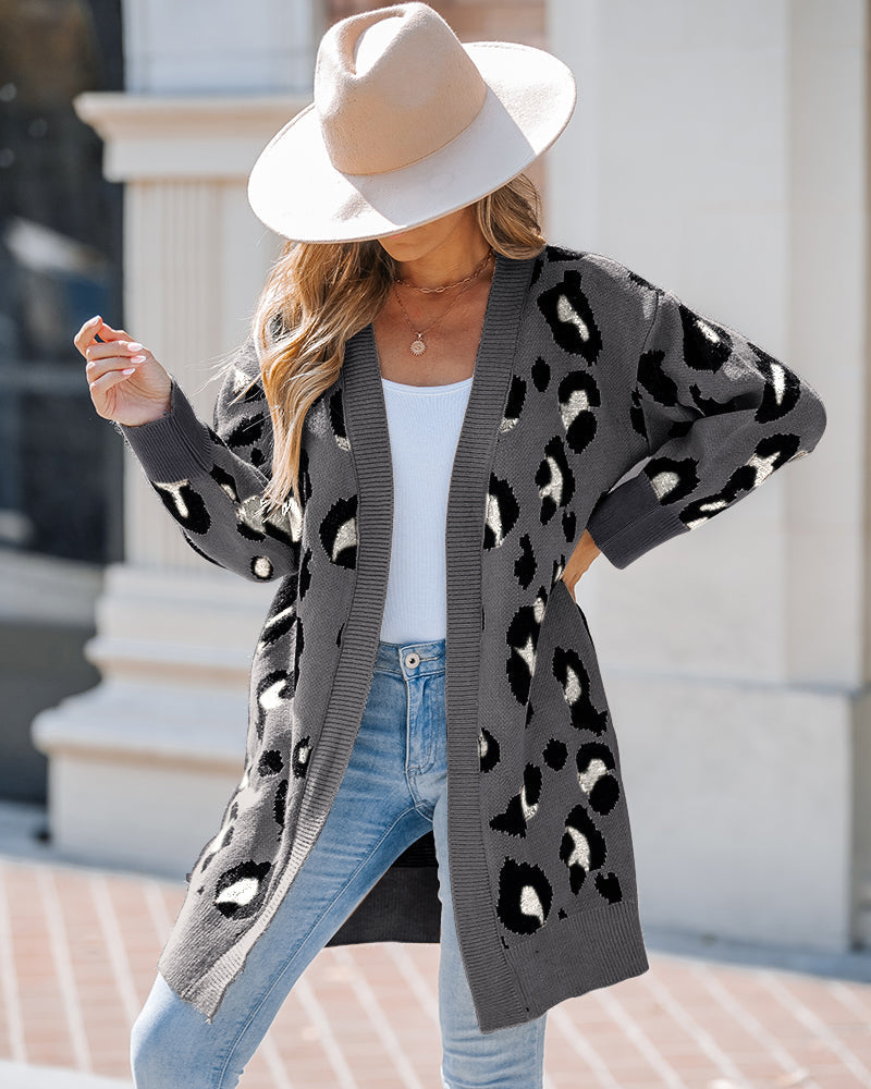Leopard print longline open-front cardigan layered over a white top and light blue jeans.