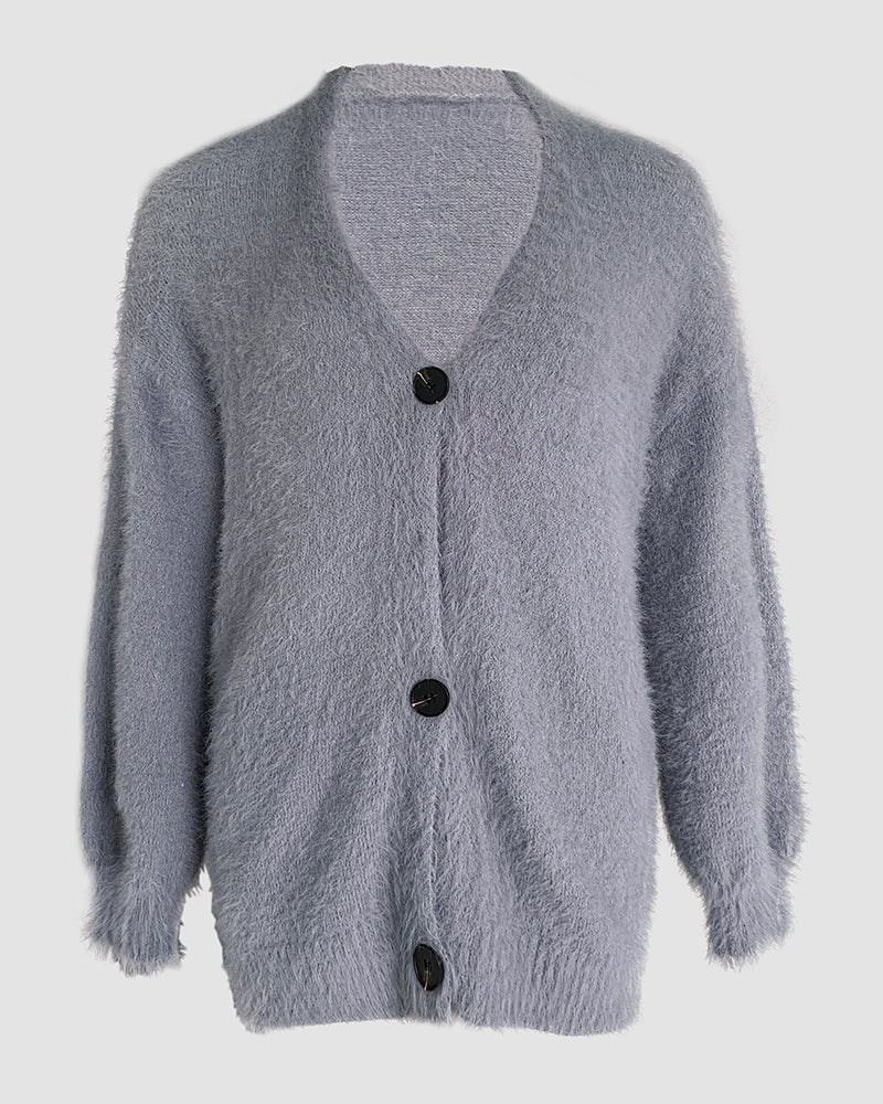 Soft gray V-neck fuzzy cardigan with long sleeves, ribbed trim, and three black buttons.