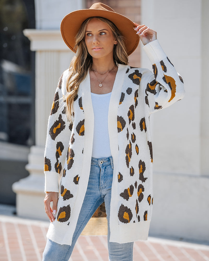 Leopard print longline cardigan with an open front, styled over a white top and blue jeans.
