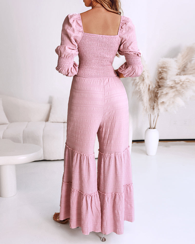 Sweetheart neck puff sleeve jumpsuit with shirring, ruffle hem, and wide legs.
