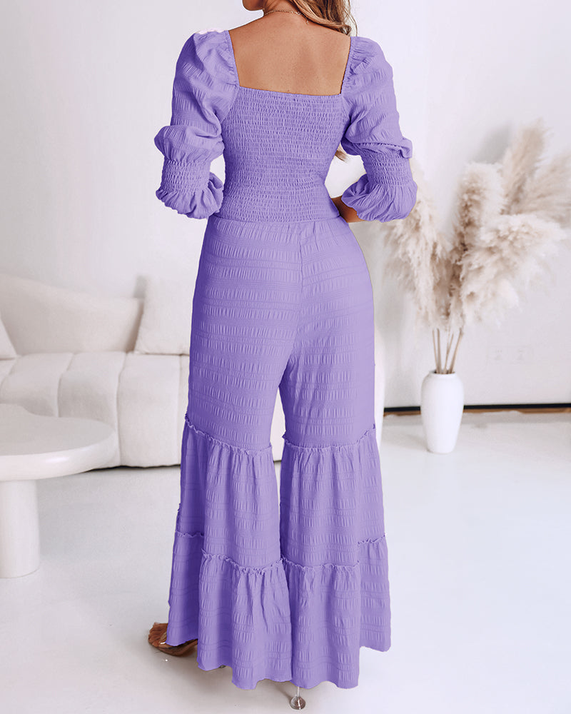 A sweetheart neck puff sleeve shirred wide leg jumpsuit with ruffle hem in white.