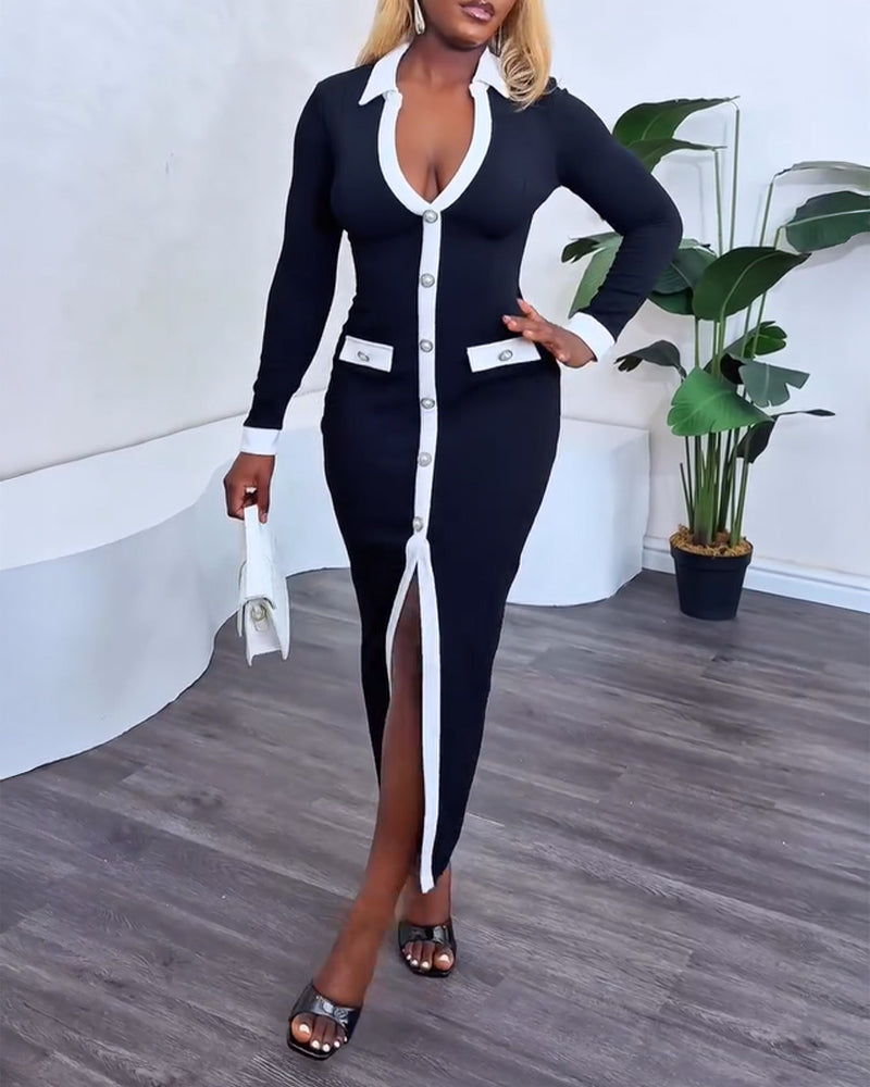 Slim fit black dress with pearl buttons, white trim, contrast panels, slit front, long sleeves.