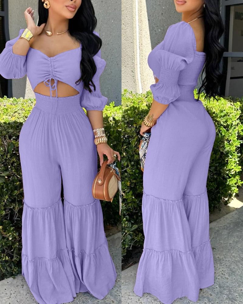 Lavender wide leg jumpsuit with sweetheart neckline, puff sleeves, shirring, and ruffled hem.