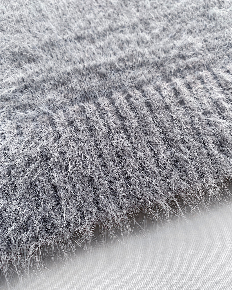 Light gray fuzzy V-neck cardigan with ribbed and smooth textures, single-breasted closure.