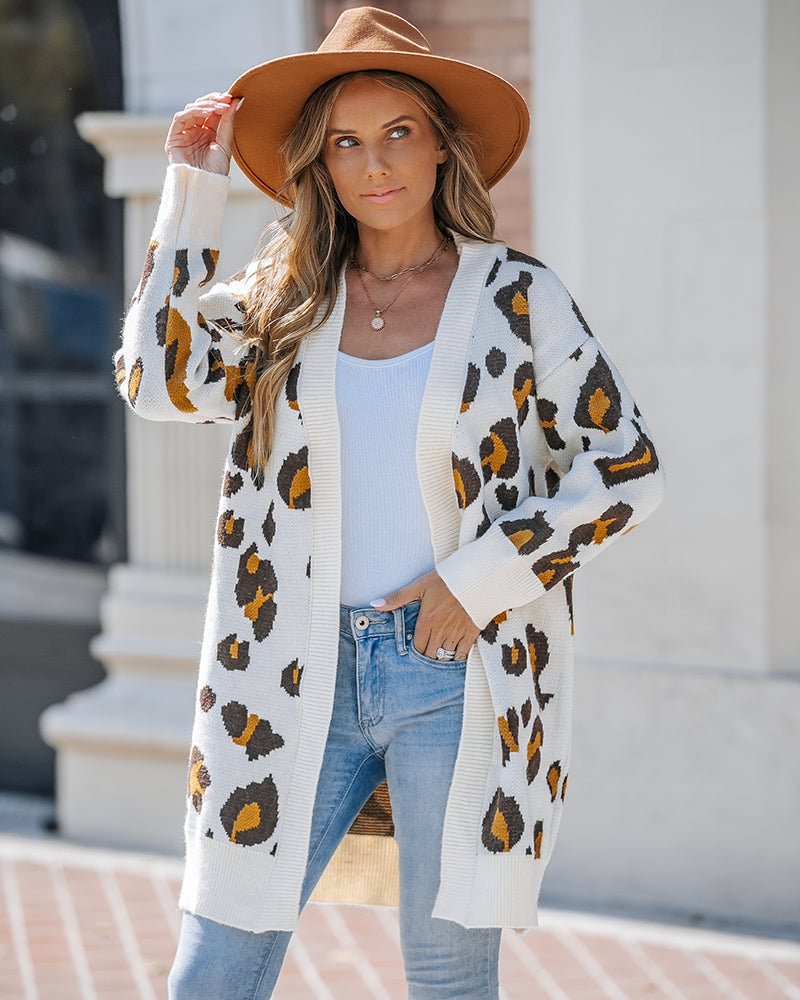 Leopard print longline open-front cardigan layered over a white top and light blue jeans.