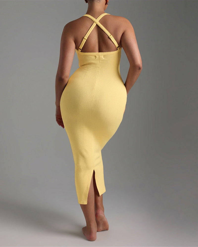 Sleeveless yellow midi dress with ribbed texture, crisscross straps, backless and back slit.
