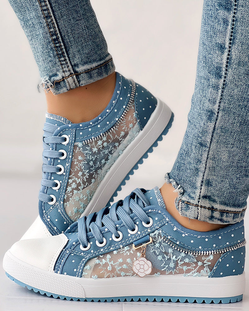 Distressed denim jeans styled with KOAD'CLO  floral embroidered polka dot print sneakers.