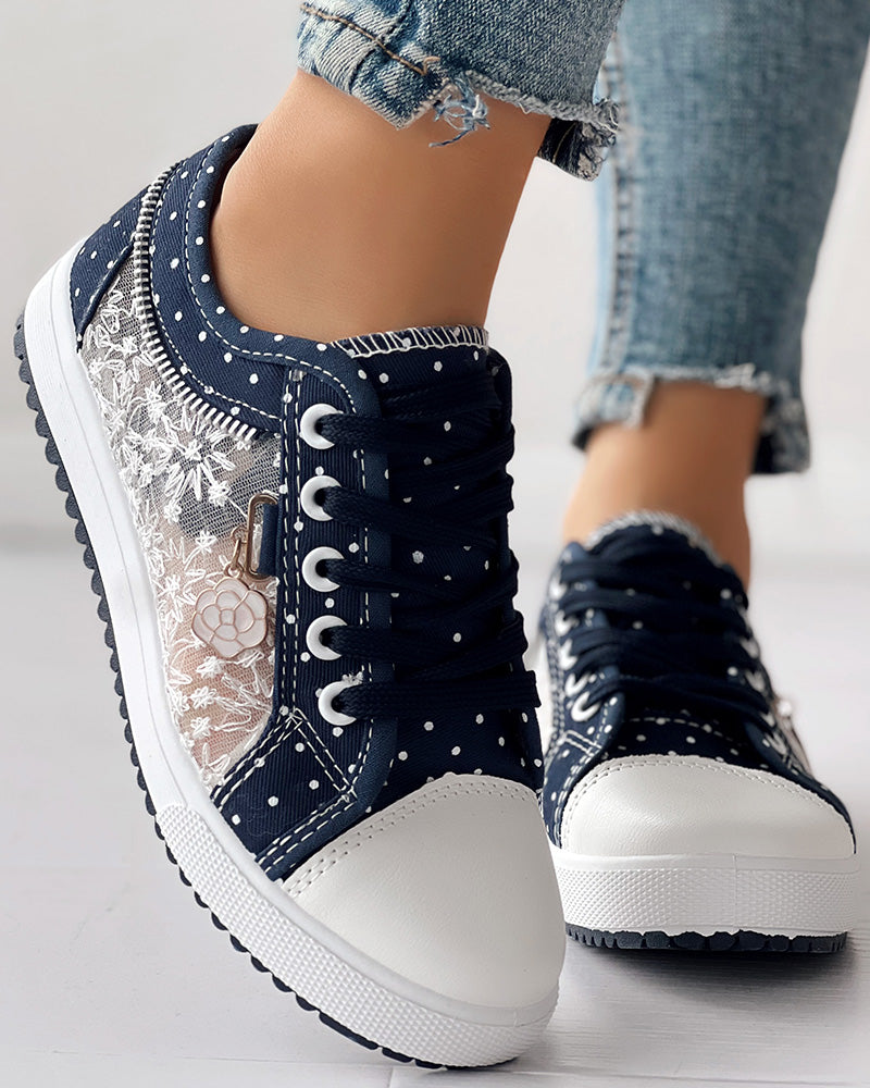 Navy KOAD'CLO sneakers with white floral embroidery, polka dots, laces; light blue frayed jeans.