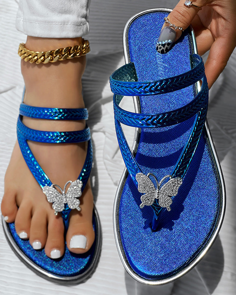 KOAD'CLOKOAD'CLO flip flops with rhinestone butterfly pattern, braided shimmer straps, and sparkling style.