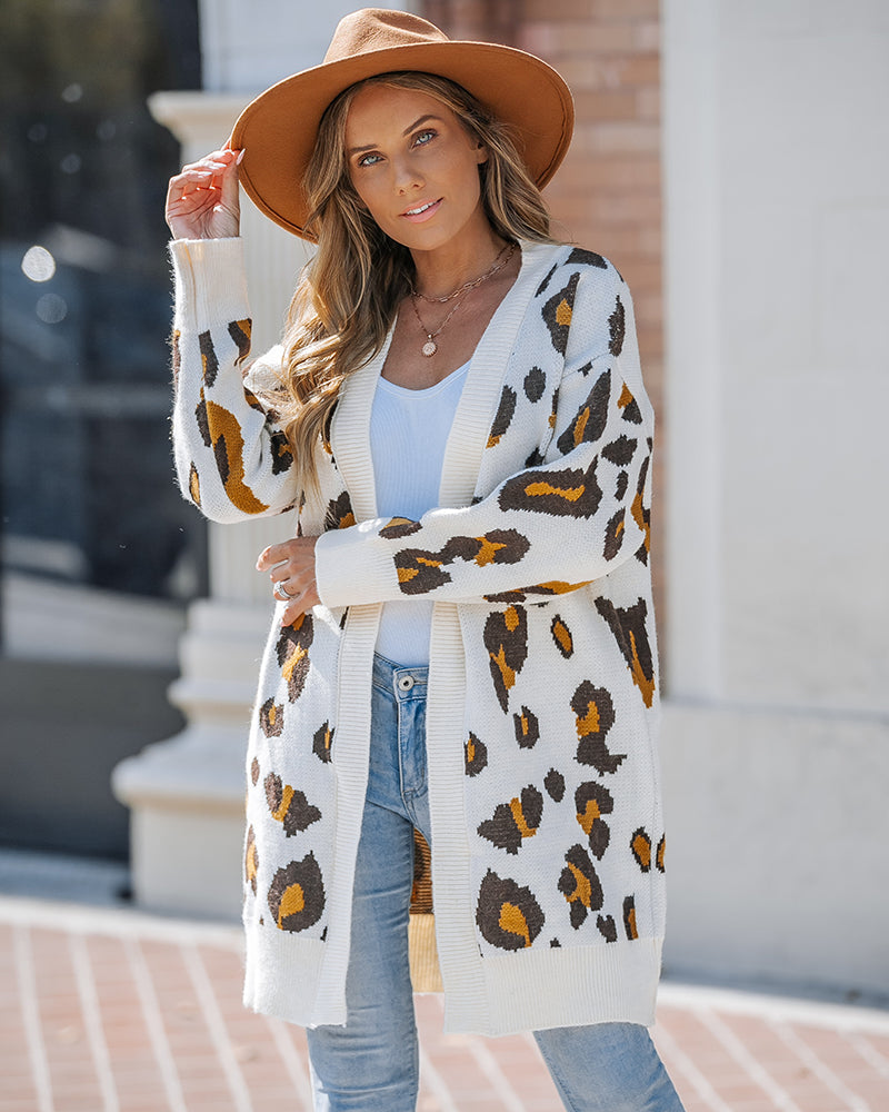 Leopard print longline cardigan with an open front, paired with a white top and light blue jeans.