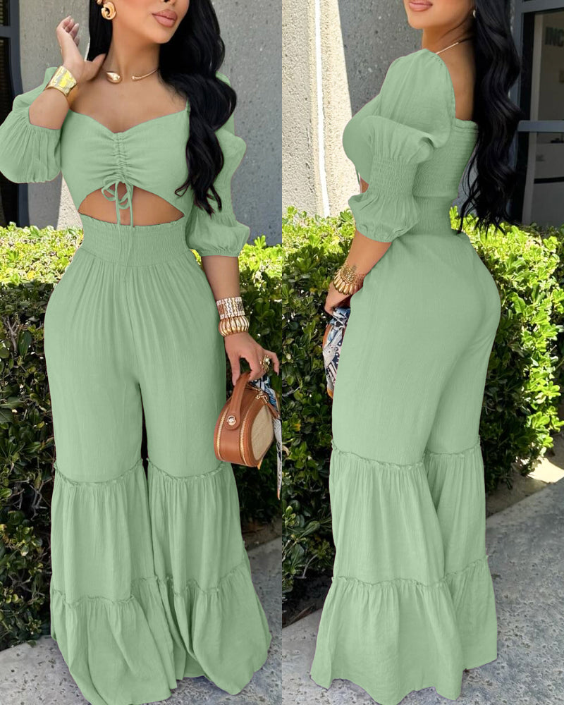 Sweetheart neck puff sleeve shirred ruffle hem wide leg jumpsuit in a vibrant color.