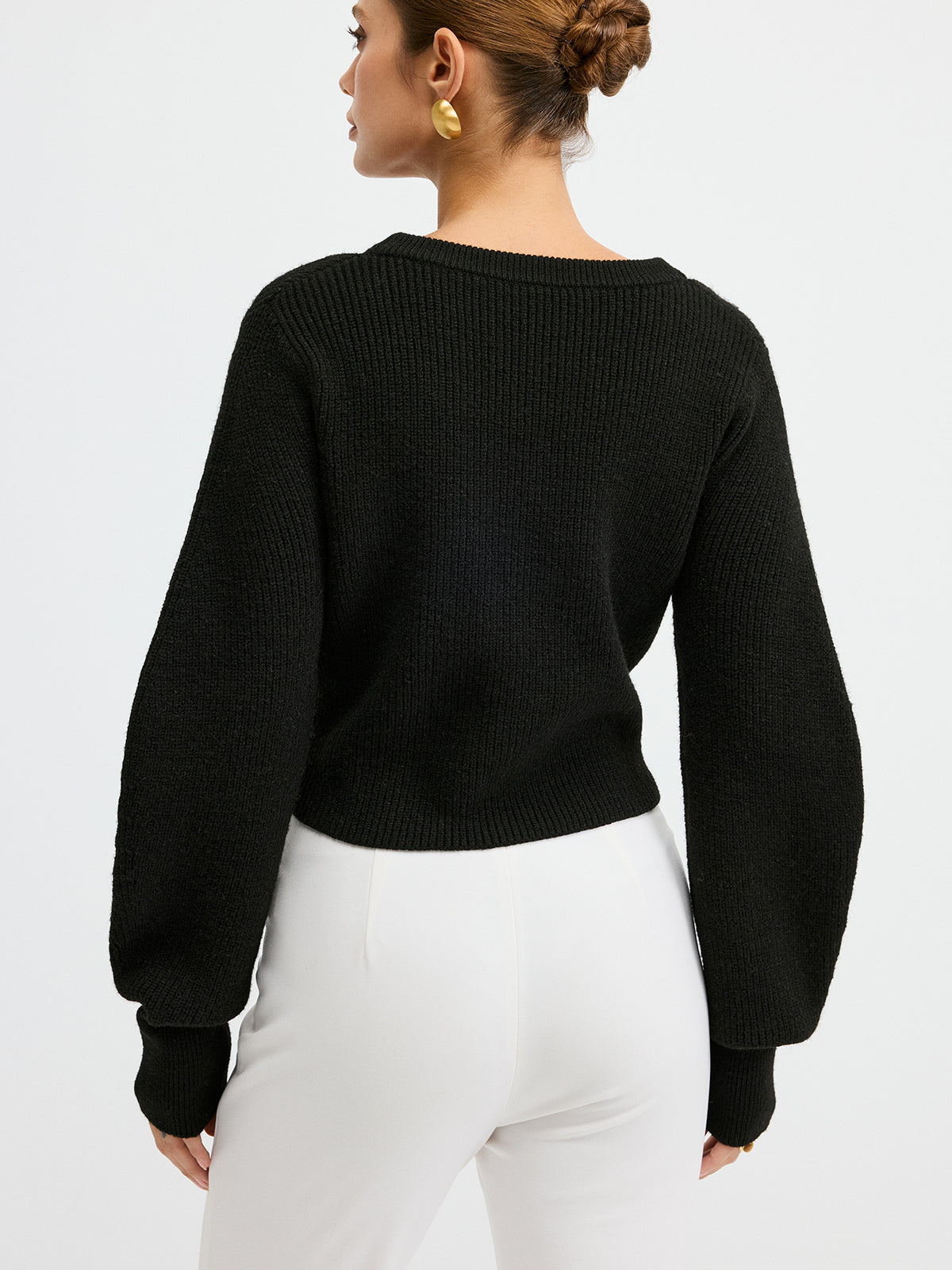 Wool blend cardigan with lace hem detail, long sleeves, and white high-waisted pants.