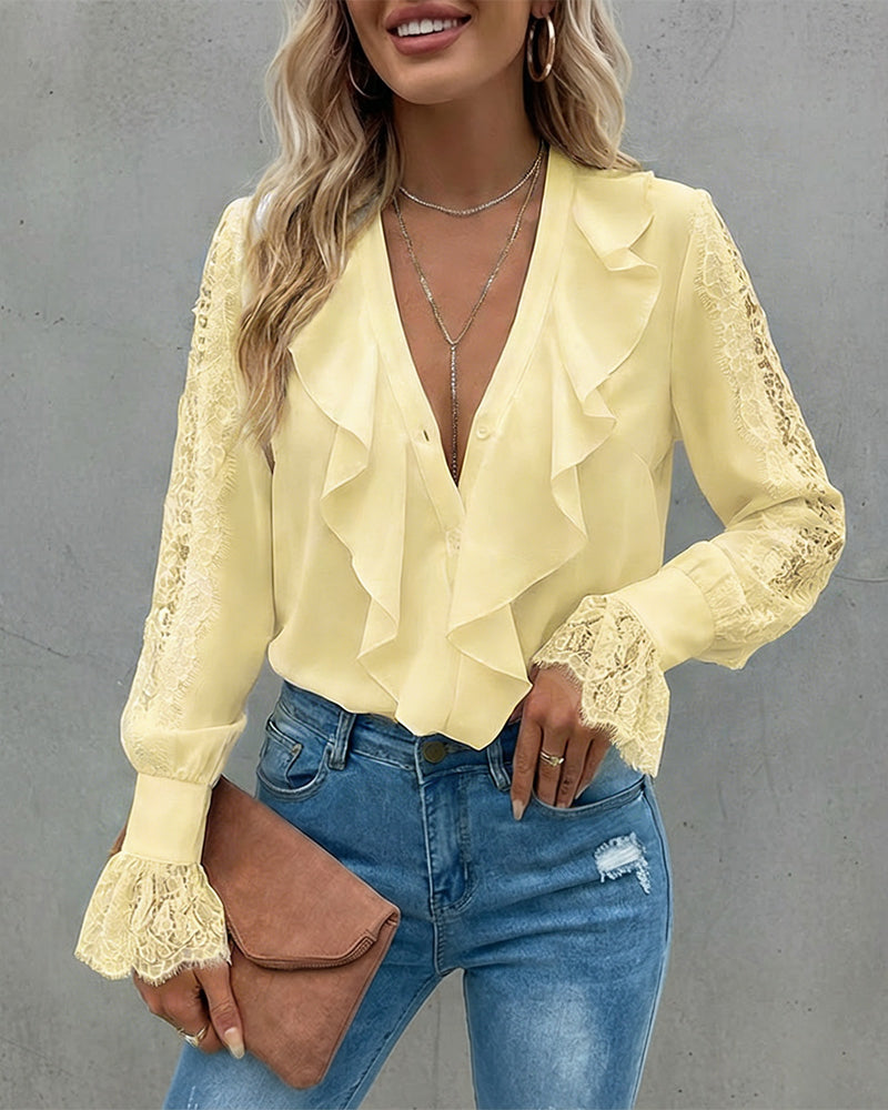 A KOAD'CLO V-Neck button-down top with eyelash lace and ruffle details and blue distressed jeans.